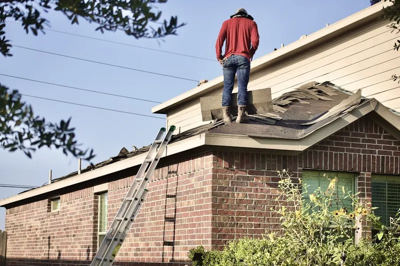 Professional roofer working on a residential roof in Del Monte Village North